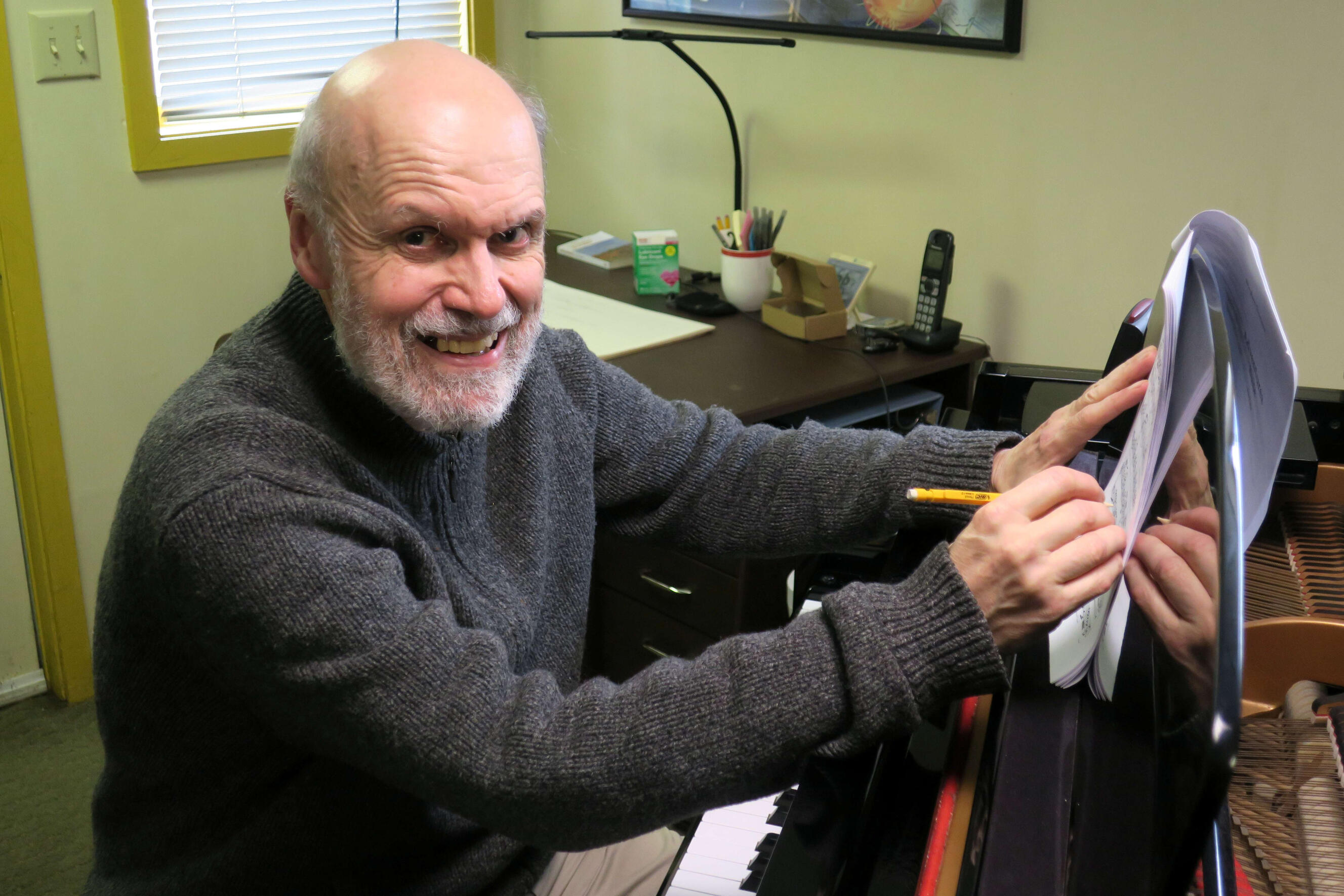 alt Stephen Demers, composer, working at the piano in his home studio.